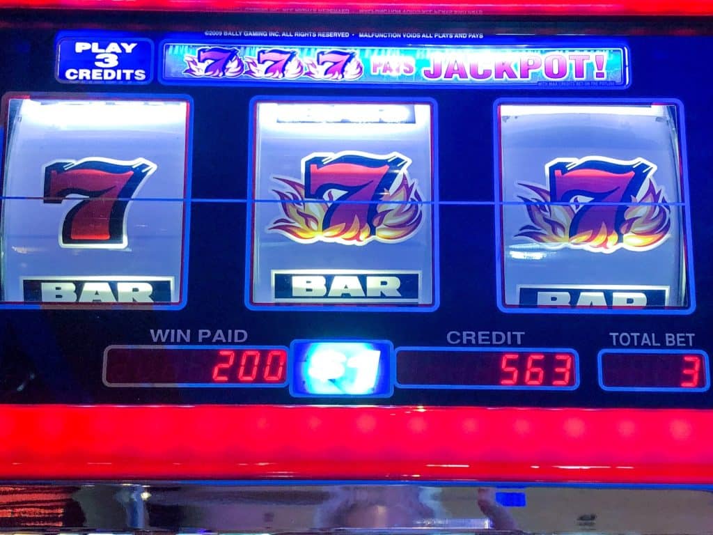 A slot machine with winning triple 7’s jackpot.